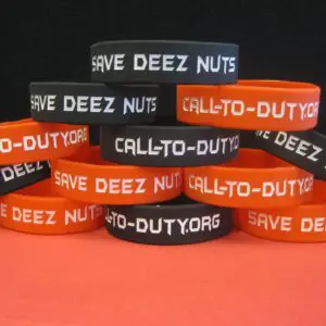 A stack of orange and black rubber bracelets that say "cal-dee-dot-nuts" Save Deez Nuts Silicone Wristband-Single.