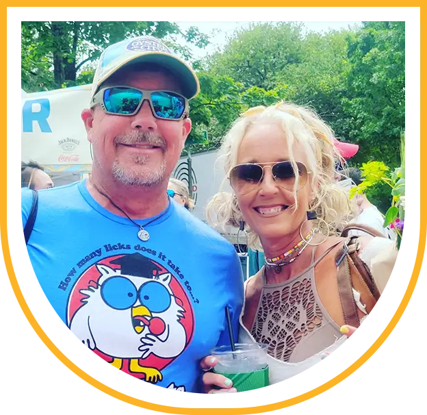 Smiling couple in sunglasses at outdoor festival